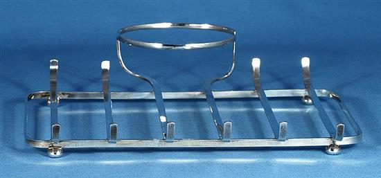 A 1930s silver asparagus draining dish with asparagus servers and sauce boat, by Goldsmiths & Silversmiths Co, tray length